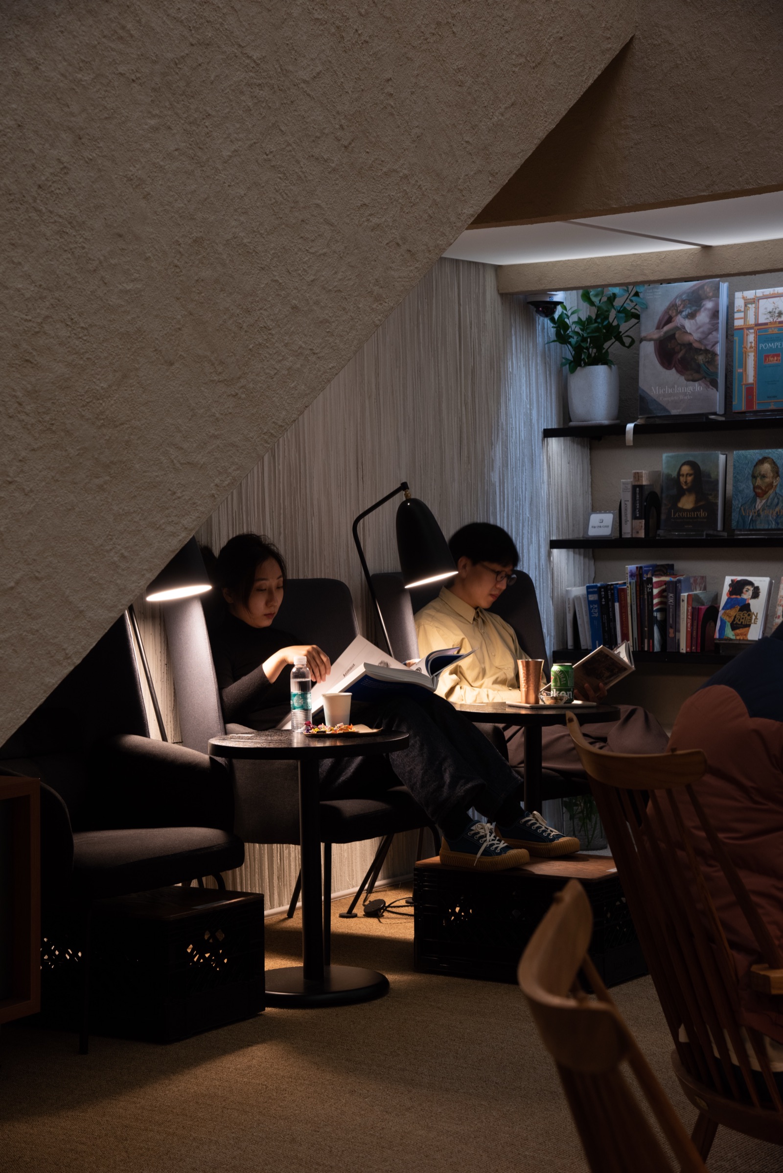 Lost in a book under a reading lamp
